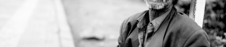 Grayscale Photography of Man Sitting